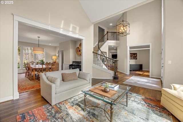 4679 Dogwood Dr, Lake Oswego, OR 97035 - living area with high vaulted ceiling, stairs, wood finished floors, a chandelier, and baseboards