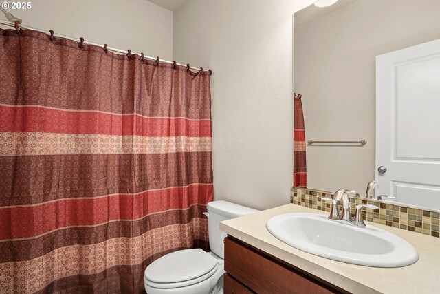 7255 NW Dusty Ter, Portland, OR 97229 - bathroom with toilet, vanity, tasteful backsplash, and curtained shower