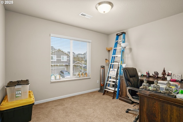 carpeted home office with baseboards and visible vents