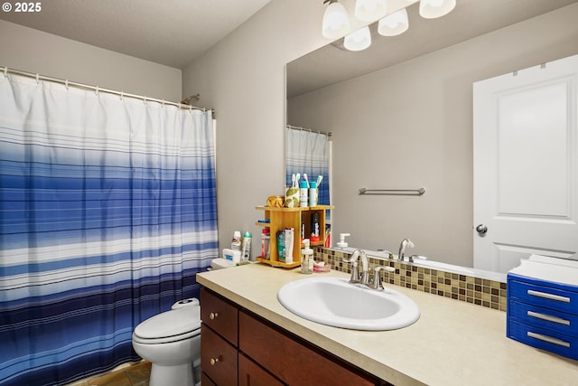 full bath with vanity, backsplash, and toilet