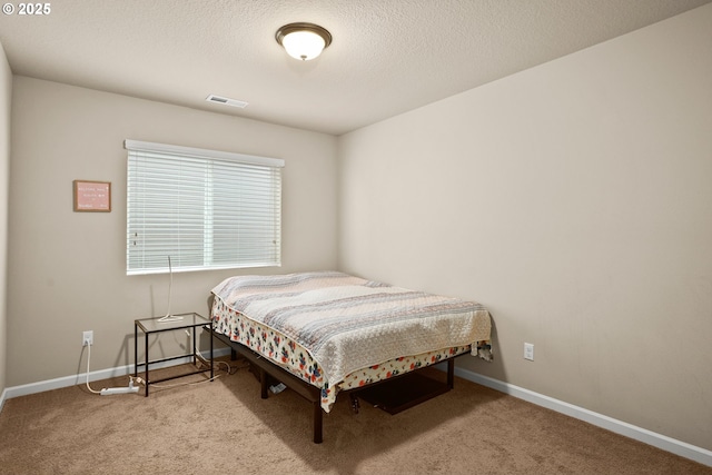 carpeted bedroom with visible vents and baseboards