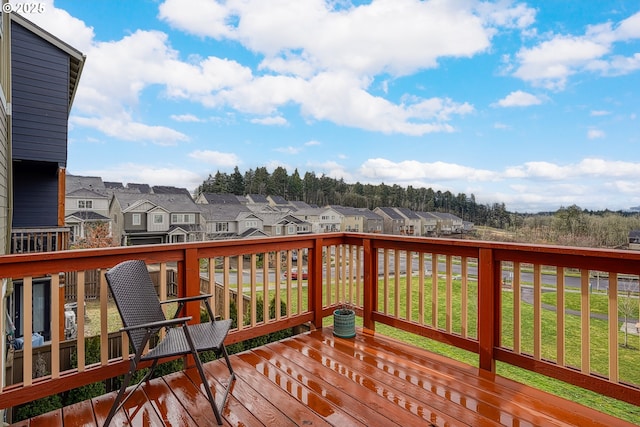 wooden deck with a yard and a residential view