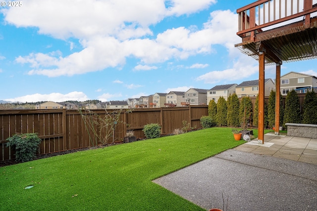 view of yard with a residential view, a fenced backyard, and a patio area