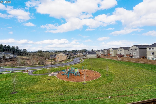 view of yard with fence, a residential view, and playground community