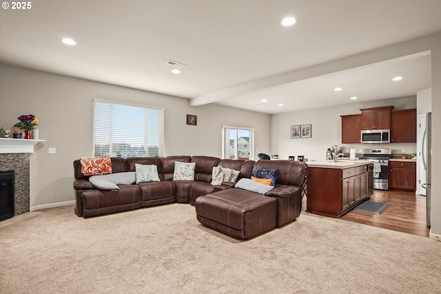 living area featuring dark colored carpet and recessed lighting
