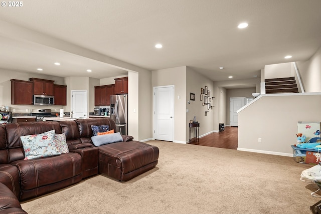 living room featuring baseboards, carpet flooring, recessed lighting, and stairs