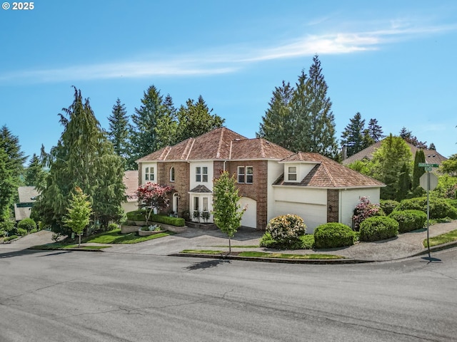 3852 Fairhaven Dr, West Linn, OR 97068 - view of front of house with concrete driveway, brick siding, and a garage