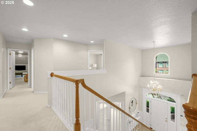 3852 Fairhaven Dr, West Linn, OR 97068 - corridor featuring an upstairs landing, light colored carpet, recessed lighting, a chandelier, and a textured ceiling