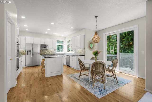 3852 Fairhaven Dr, West Linn, OR 97068 - dining space featuring light wood-type flooring, recessed lighting, and a textured ceiling