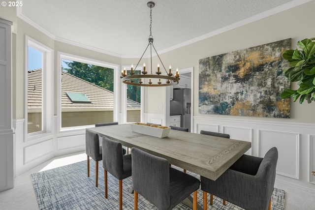3852 Fairhaven Dr, West Linn, OR 97068 - dining room featuring a decorative wall, a chandelier, crown molding, wainscoting, and light colored carpet