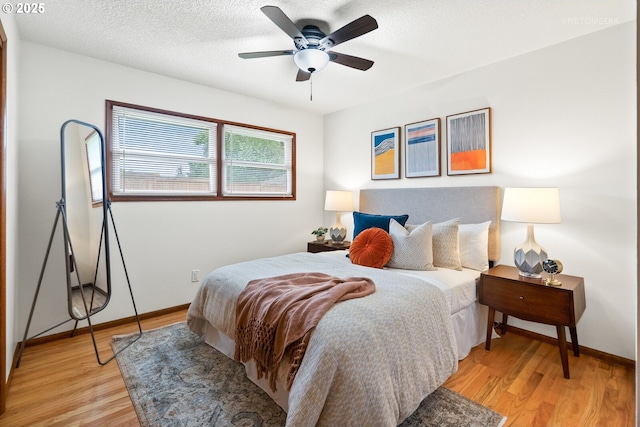 13140 SW Edgewood St, Portland, OR 97225 - bedroom with light wood-style floors, baseboards, ceiling fan, and a textured ceiling