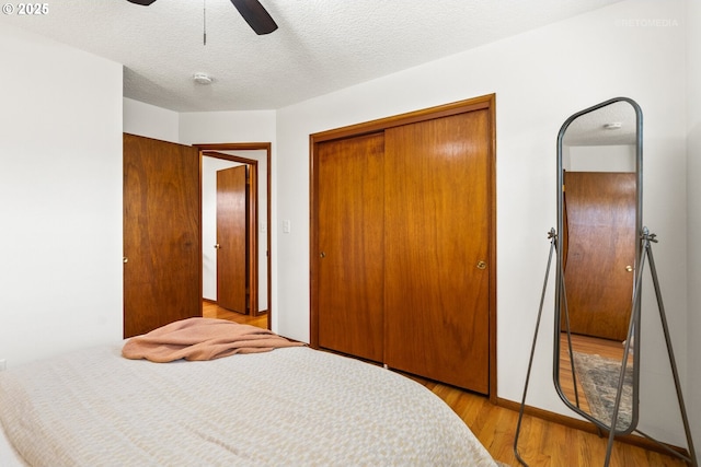 13140 SW Edgewood St, Portland, OR 97225 - bedroom featuring a closet, wood finished floors, a ceiling fan, and a textured ceiling