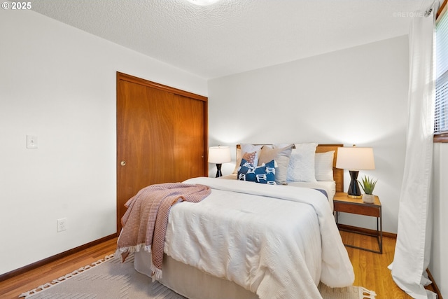 13140 SW Edgewood St, Portland, OR 97225 - bedroom with a closet, wood finished floors, and baseboards