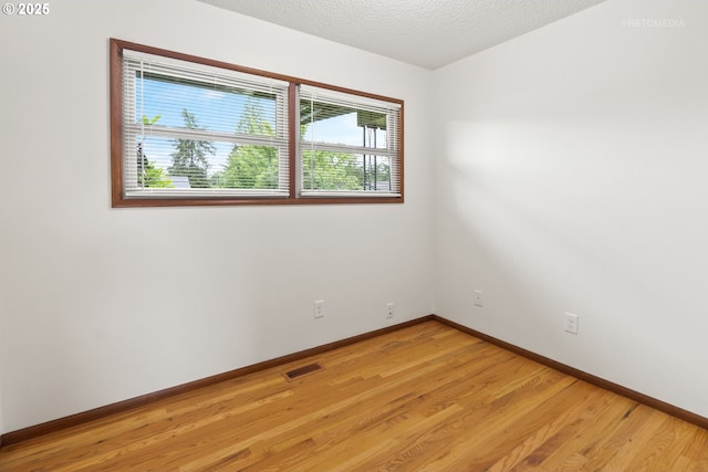 13140 SW Edgewood St, Portland, OR 97225 - spare room with light wood finished floors, baseboards, and a textured ceiling