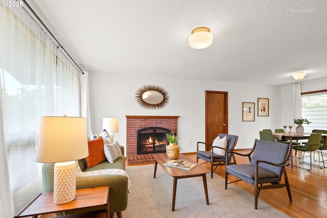 13140 SW Edgewood St, Portland, OR 97225 - living area with a fireplace, light wood-style floors, and a textured ceiling