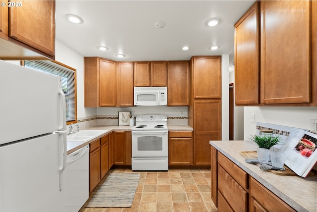 13140 SW Edgewood St, Portland, OR 97225 - kitchen featuring white appliances, a sink, light countertops, recessed lighting, and brown cabinets