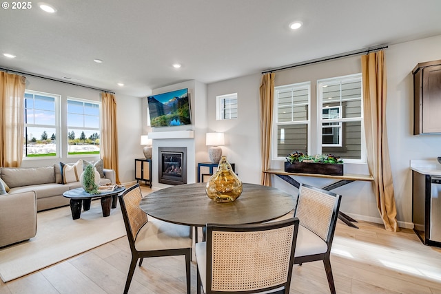 966 Legacy Ln, Eugene, OR 97402 - dining space with plenty of natural light, a glass covered fireplace, light wood-style floors, and recessed lighting