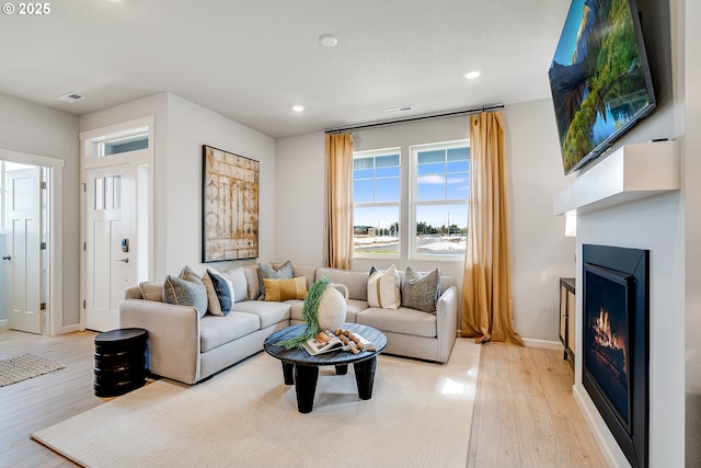 966 Legacy Ln, Eugene, OR 97402 - living room with light wood-type flooring, a lit fireplace, and recessed lighting