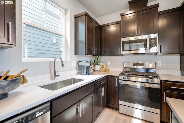 966 Legacy Ln, Eugene, OR 97402 - kitchen featuring stainless steel appliances, dark brown cabinetry, and light countertops