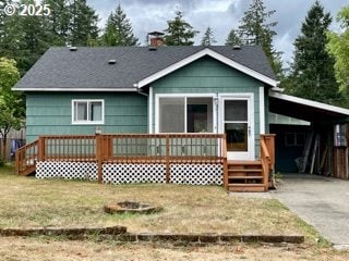 313 Taylor St, Ryderwood, WA 98581 - back of property featuring an attached carport, a lawn, a chimney, a deck, and driveway