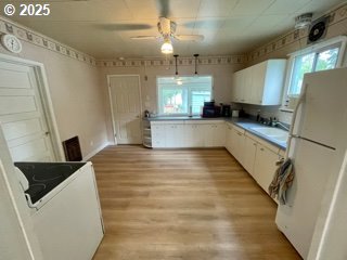313 Taylor St, Ryderwood, WA 98581 - kitchen featuring plenty of natural light, light wood-style floors, freestanding refrigerator, and ceiling fan