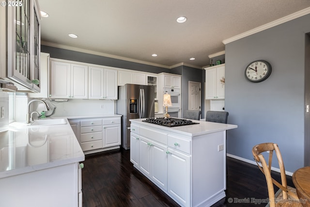 kitchen featuring white cabinetry, black gas stovetop, a kitchen island, and sink