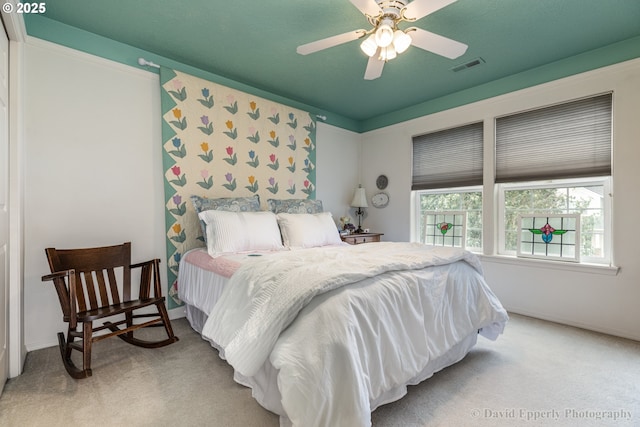 bedroom featuring ceiling fan and carpet