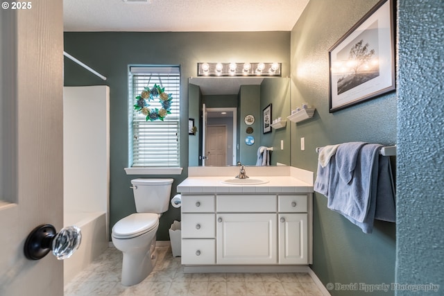 full bathroom with toilet, vanity, shower / washtub combination, and a textured ceiling