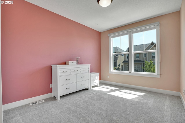 bedroom with visible vents, baseboards, and light colored carpet