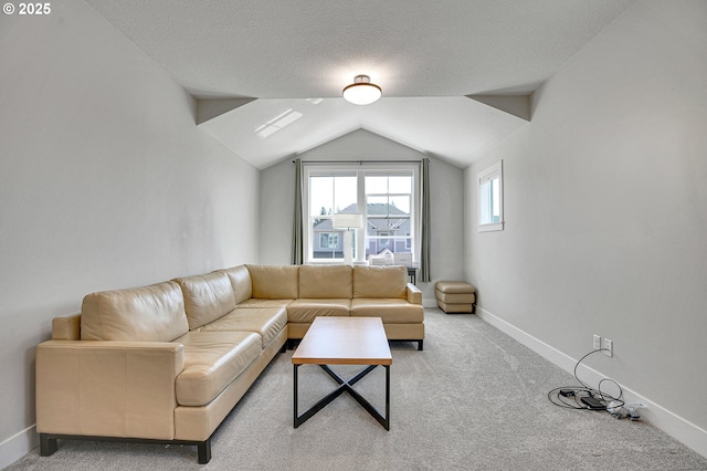 living room with light colored carpet, a textured ceiling, baseboards, and lofted ceiling