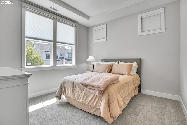bedroom with baseboards, carpet, and visible vents