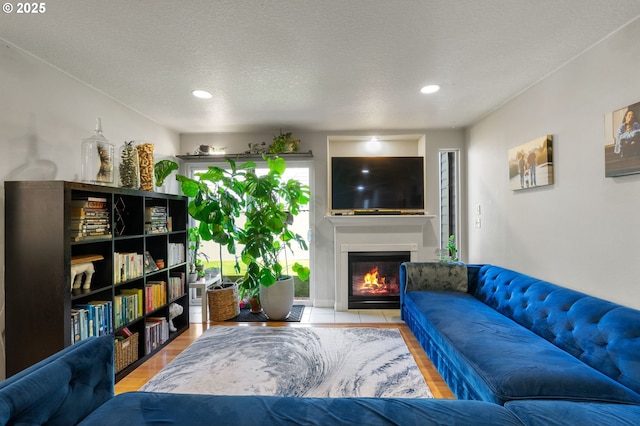17881 SW Pars Pl, Beaverton, OR 97078 - living area featuring a glass covered fireplace, recessed lighting, and wood finished floors