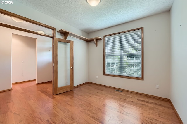 4202 SE 31st St, Gresham, OR 97080 - unfurnished room with light wood finished floors, french doors, a textured ceiling, and baseboards