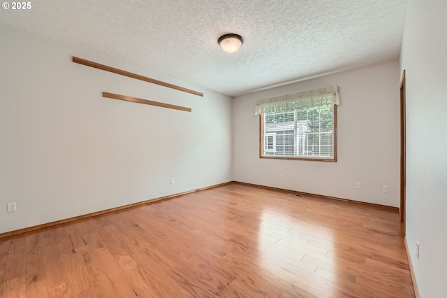 4202 SE 31st St, Gresham, OR 97080 - unfurnished room featuring light wood-style floors, a textured ceiling, and baseboards