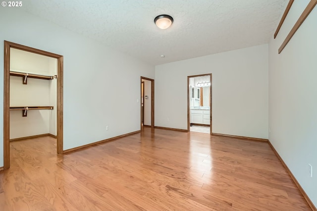4202 SE 31st St, Gresham, OR 97080 - unfurnished bedroom featuring light wood-style floors, a textured ceiling, and baseboards