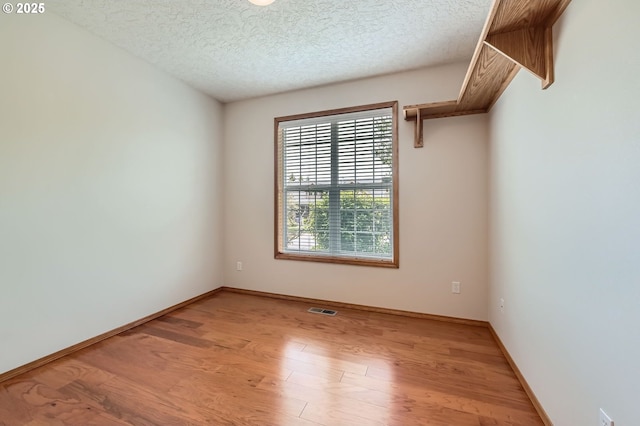 4202 SE 31st St, Gresham, OR 97080 - spare room featuring light wood-type flooring, a textured ceiling, and baseboards