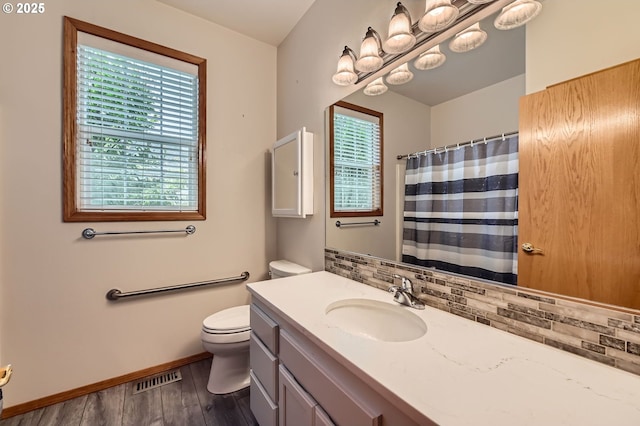 4202 SE 31st St, Gresham, OR 97080 - bathroom with tasteful backsplash, toilet, wood finished floors, vanity, and baseboards