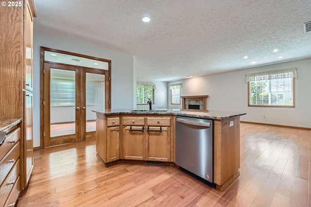 4202 SE 31st St, Gresham, OR 97080 - kitchen with dishwasher, open floor plan, a sink, light wood-style flooring, and plenty of natural light