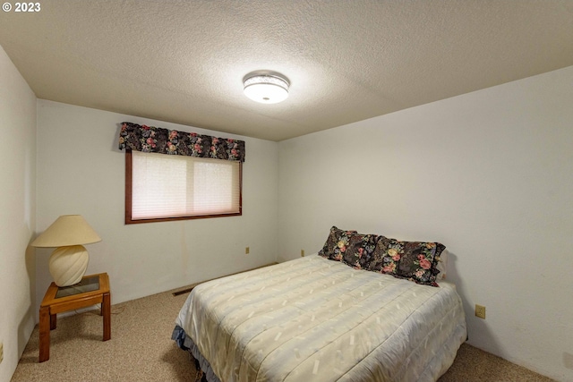 bedroom featuring a textured ceiling and carpet floors