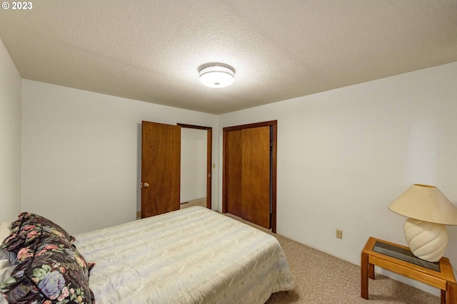 bedroom with carpet and a textured ceiling