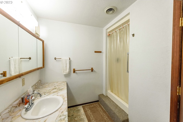 bathroom with vanity and a shower with shower curtain