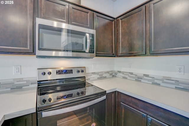 2153 NE 118th Pl, Vancouver, WA 98684 - kitchen featuring stainless steel appliances, dark brown cabinets, tasteful backsplash, and light countertops