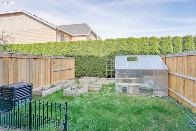 2153 NE 118th Pl, Vancouver, WA 98684 - view of yard with a greenhouse, a garden, and an outbuilding