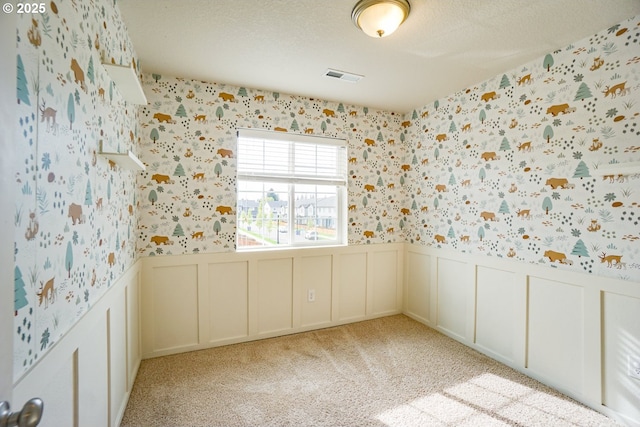 2153 NE 118th Pl, Vancouver, WA 98684 - empty room with wallpapered walls, wainscoting, a decorative wall, light colored carpet, and a textured ceiling
