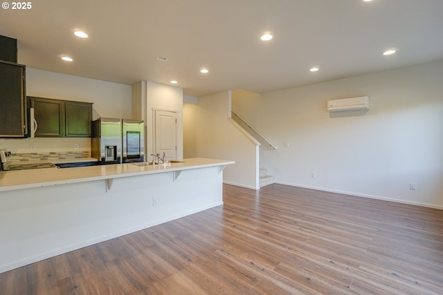 2153 NE 118th Pl, Vancouver, WA 98684 - kitchen with appliances with stainless steel finishes, a sink, a wall unit AC, a peninsula, and a breakfast bar area