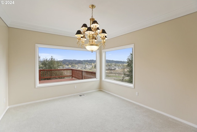 unfurnished room featuring ornamental molding, carpet flooring, a mountain view, and a notable chandelier