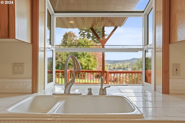 interior space with a mountain view and sink