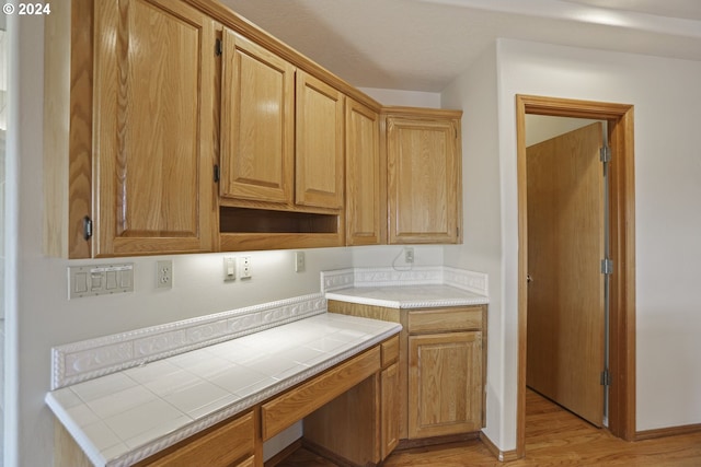 laundry area with light wood-type flooring