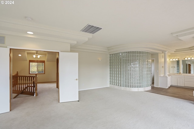 spare room with decorative columns, crown molding, carpet floors, and ceiling fan