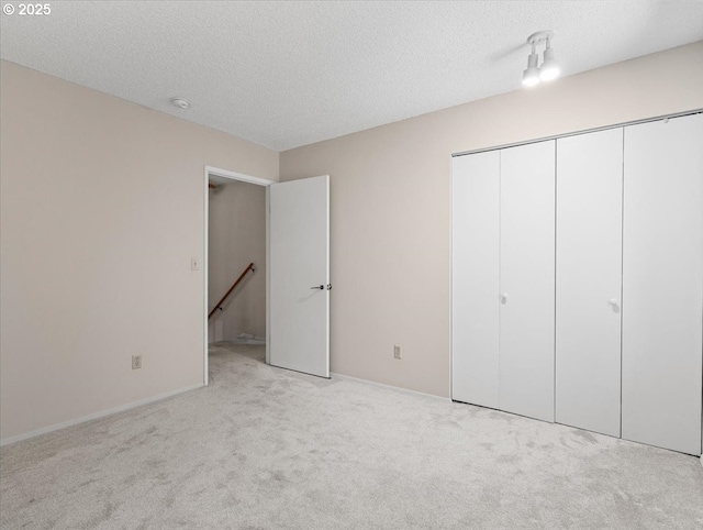 8512 SW Brightfield Cir, Tigard, OR 97223 - unfurnished bedroom featuring carpet flooring, a closet, a textured ceiling, and baseboards